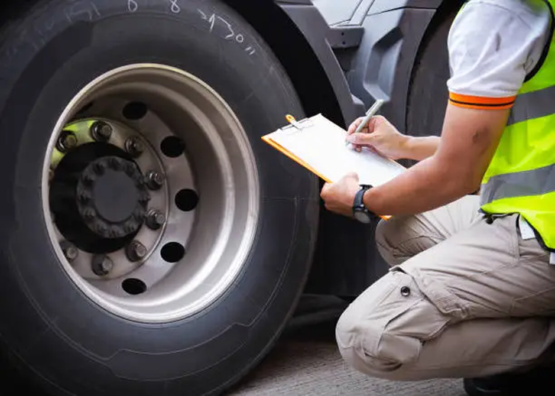 Safety vest hanging by a truck wheel